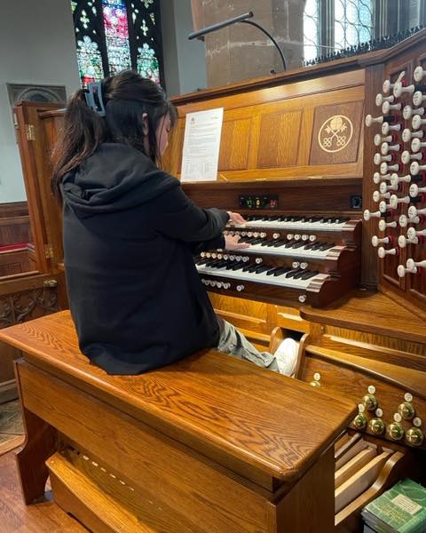girl playing organ at St Peters Church