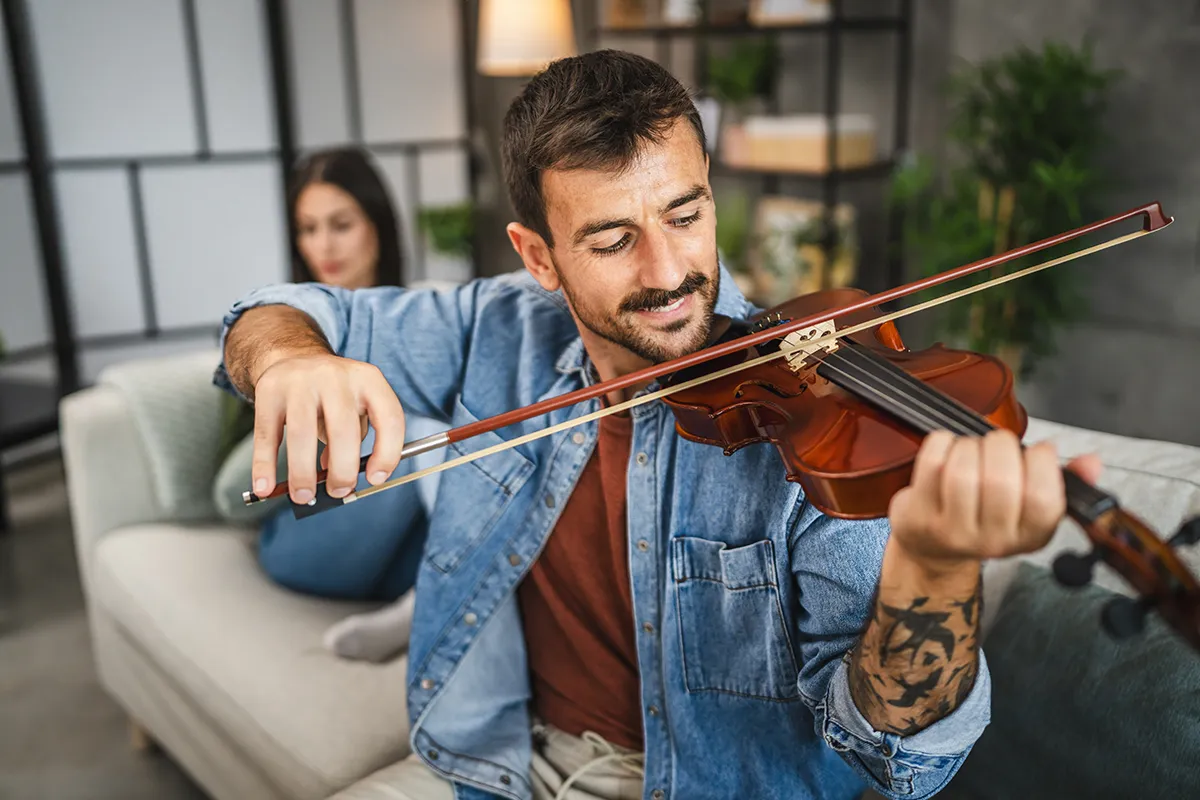 Man learning to play violin